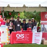Colorful outdoor booth at a brain injury awareness event, promoting neuro skills and heart-brain health.