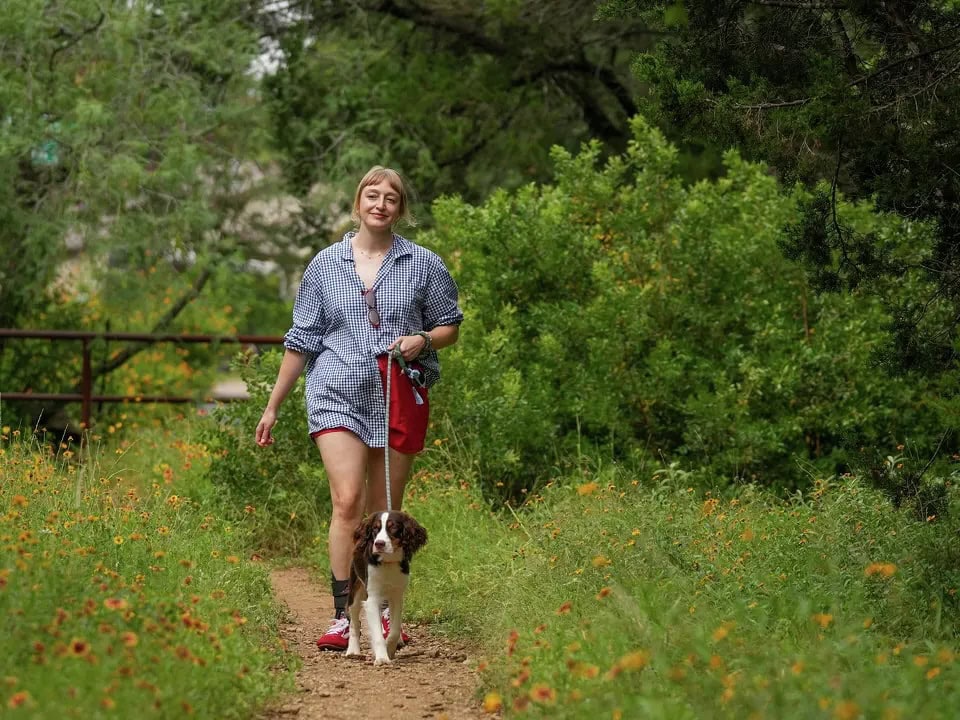 CNS patient Lillian Angelle walking her dog.